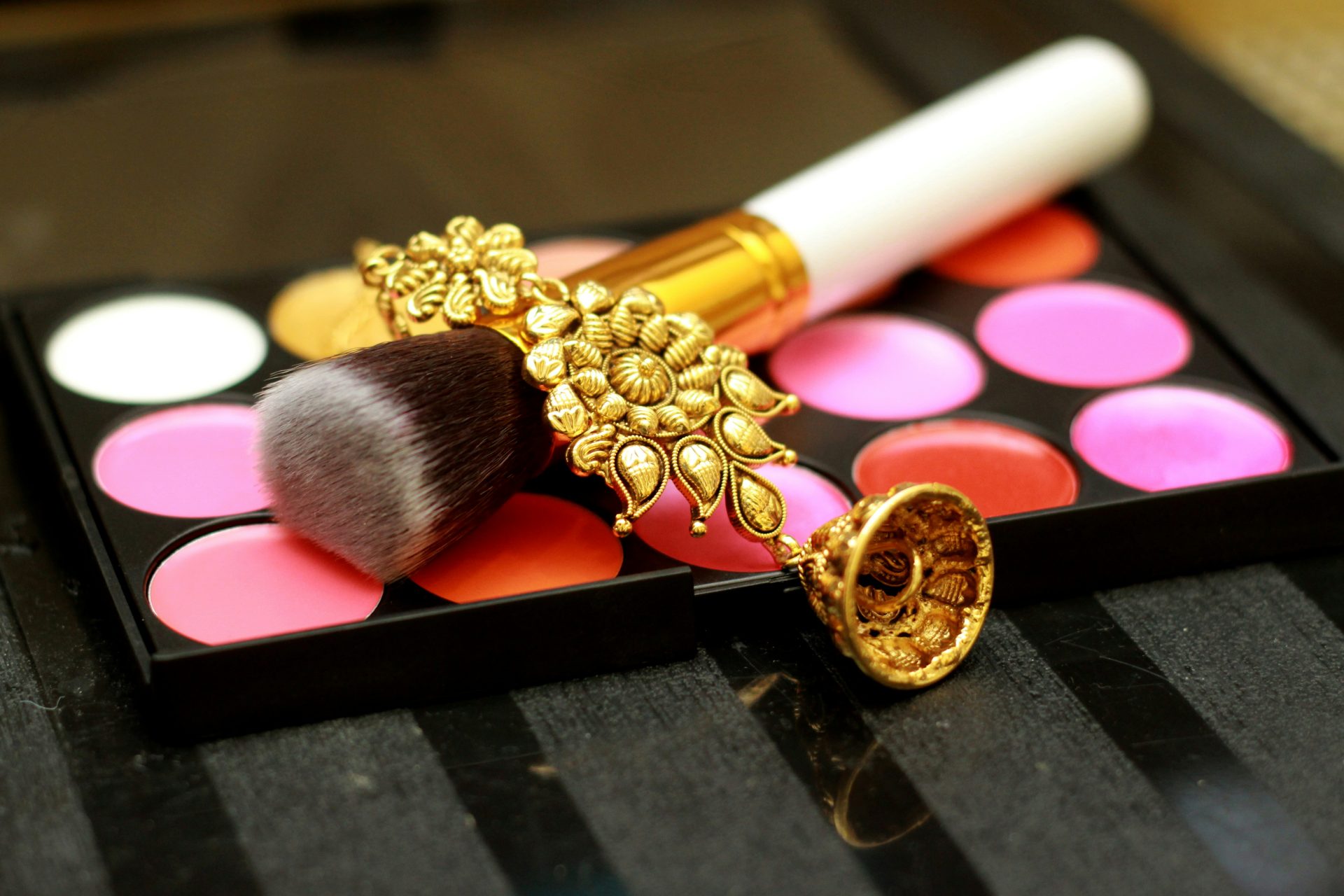 gold-colored drop earring and foundation kit