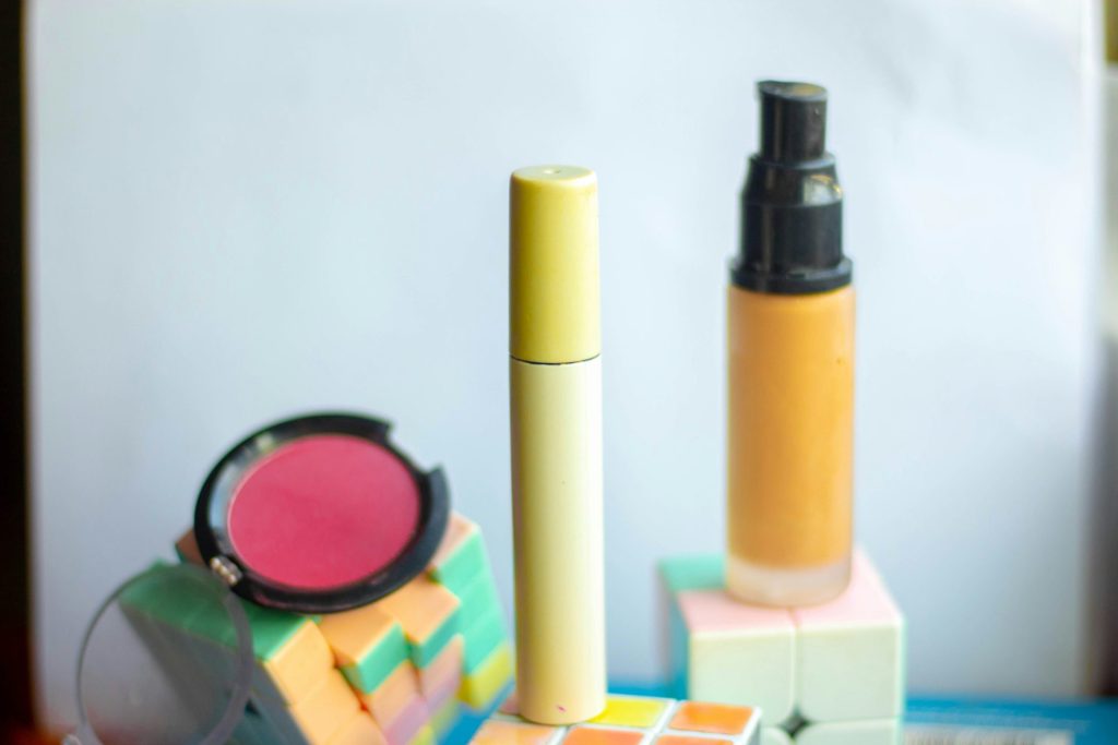 a close up of a lipstick and a mirror